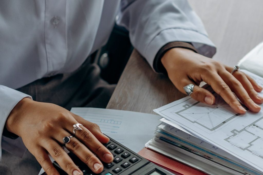Professional reviewing business working capital documents with a calculator